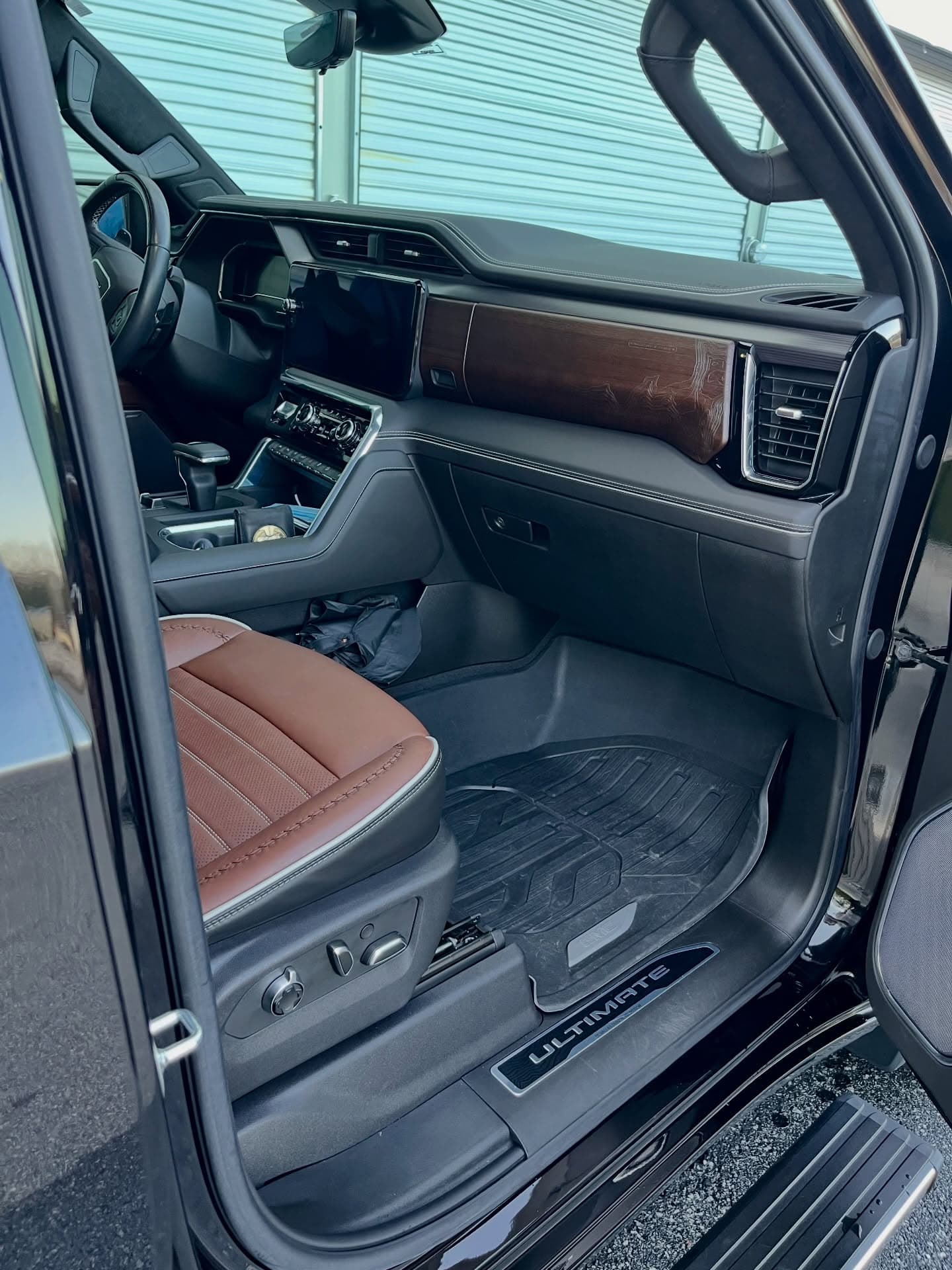 Spotless detailed truck interior — clean leather seats and wood-trim dash after an Adams Package interior detail, Cumming GA